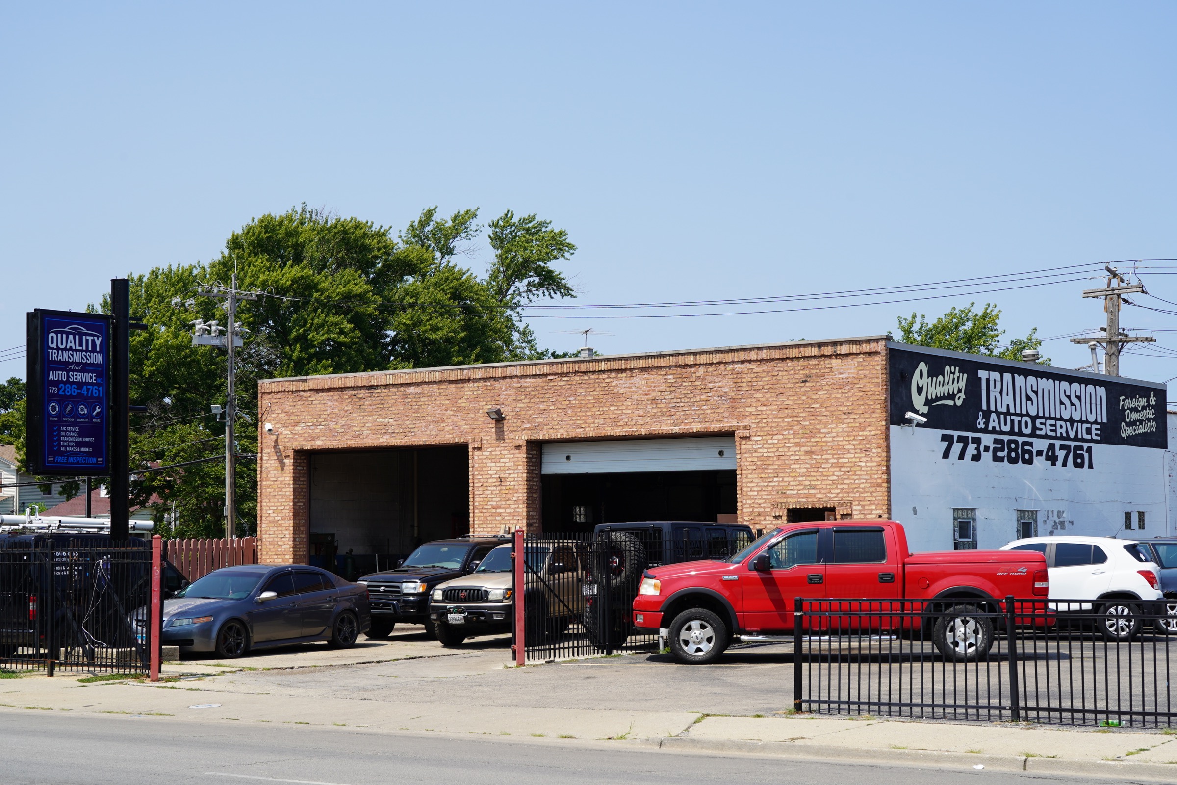 Quality Transmission shop with the new blue sign